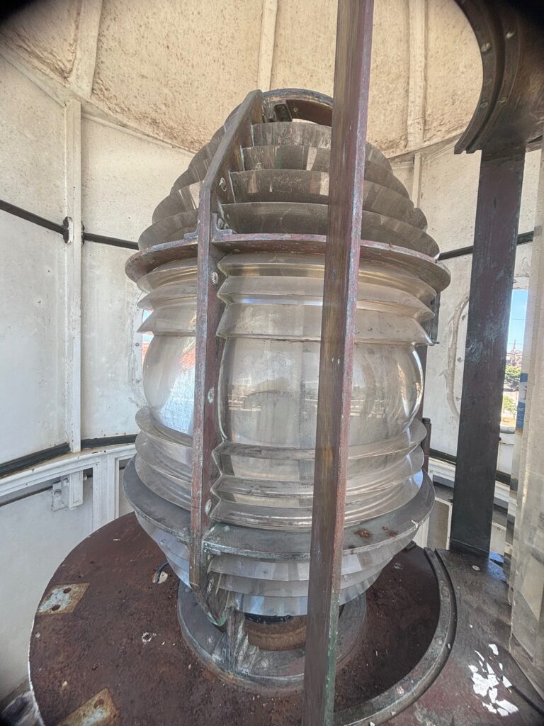 a glass light house with a ladder