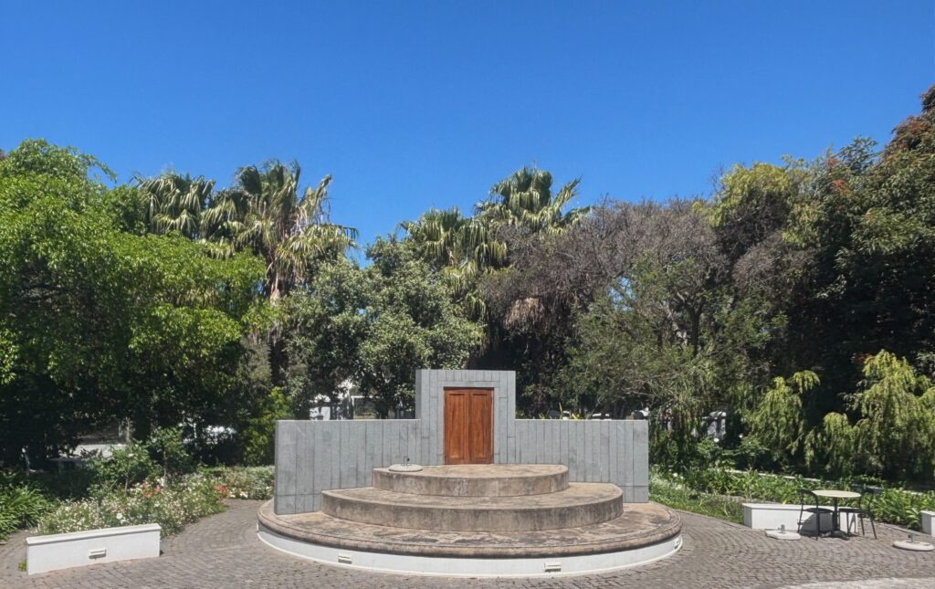 a circular stone structure with a door and steps