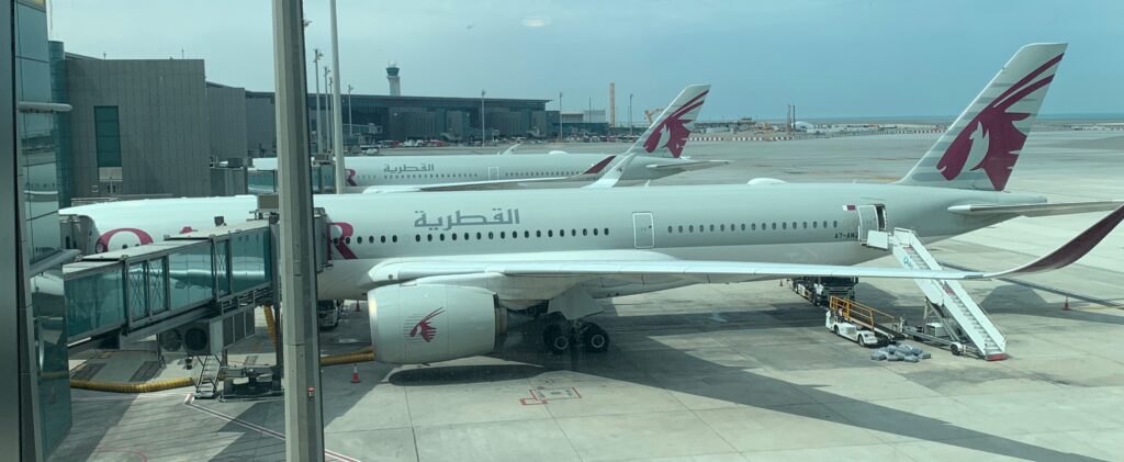 a group of airplanes parked at an airport