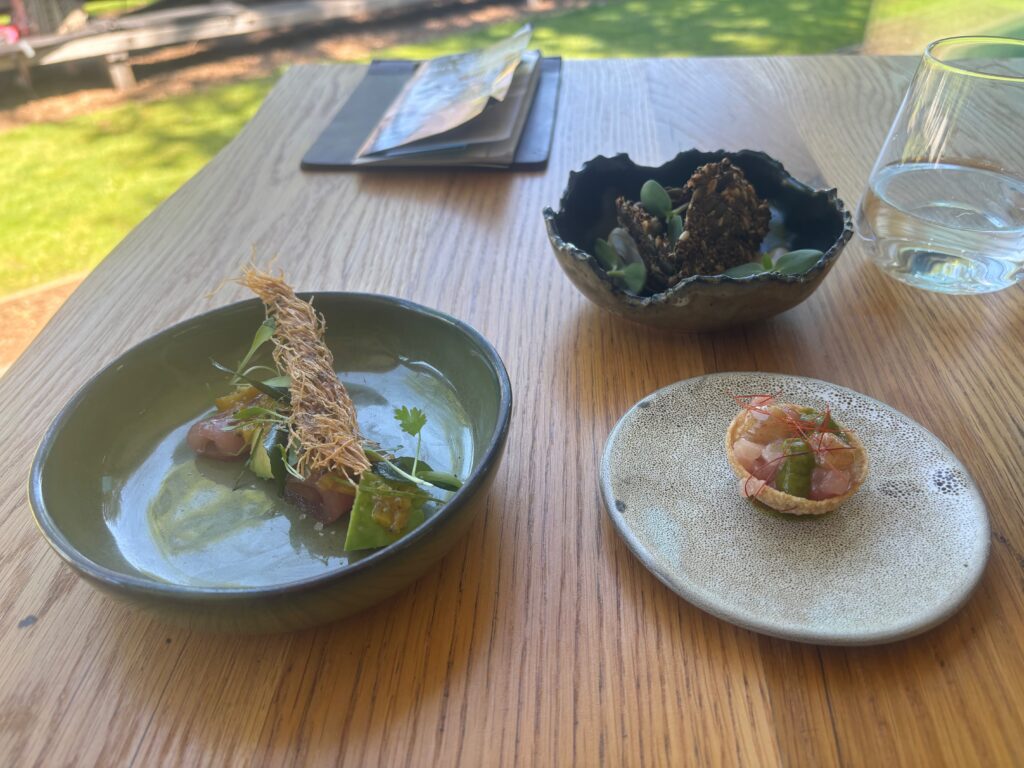 a bowl of soup and a small plate of food on a table