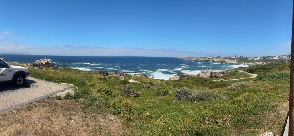 a landscape with a body of water and a city