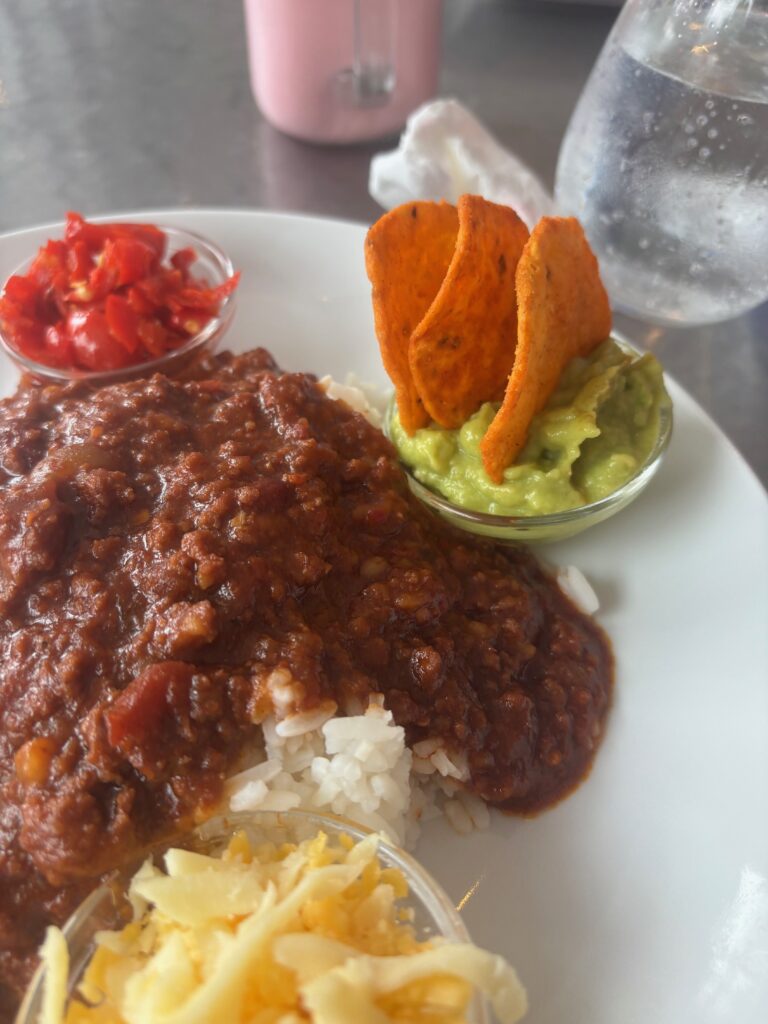 a plate of food with chips and sauce