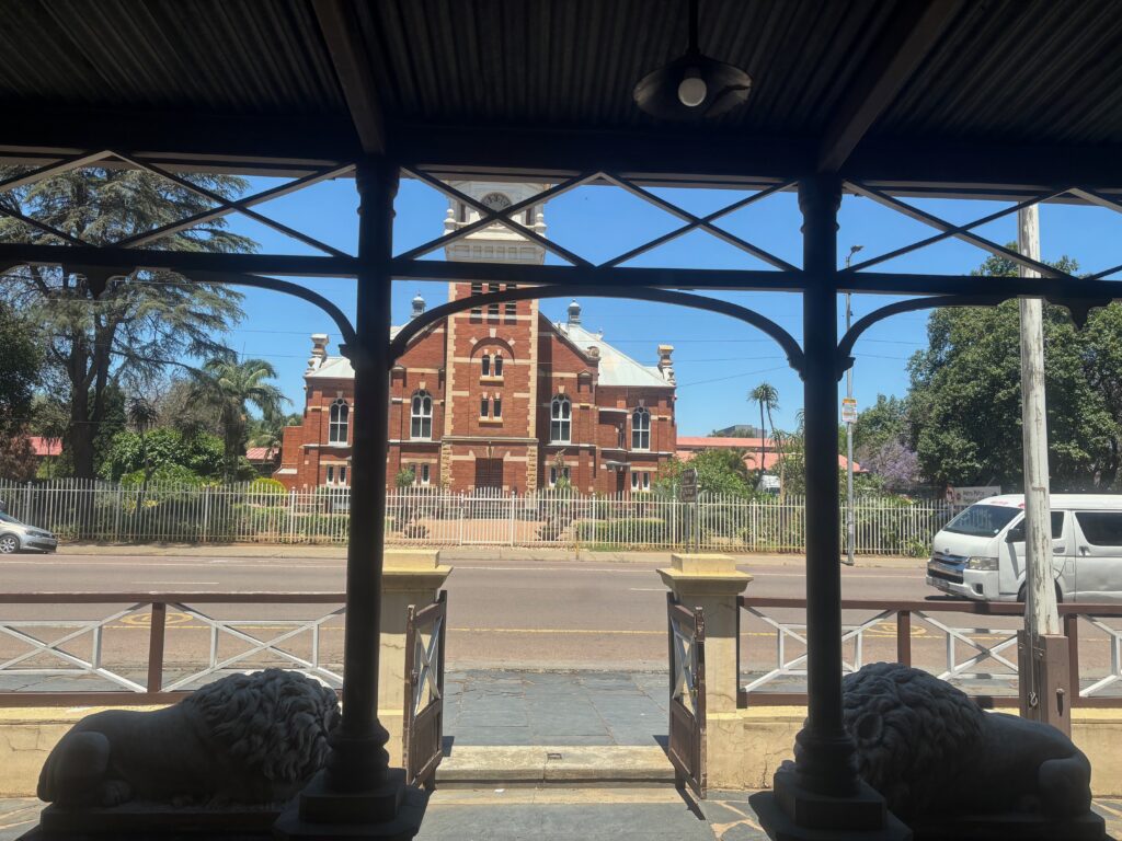 a building with a white fence and a white gate
