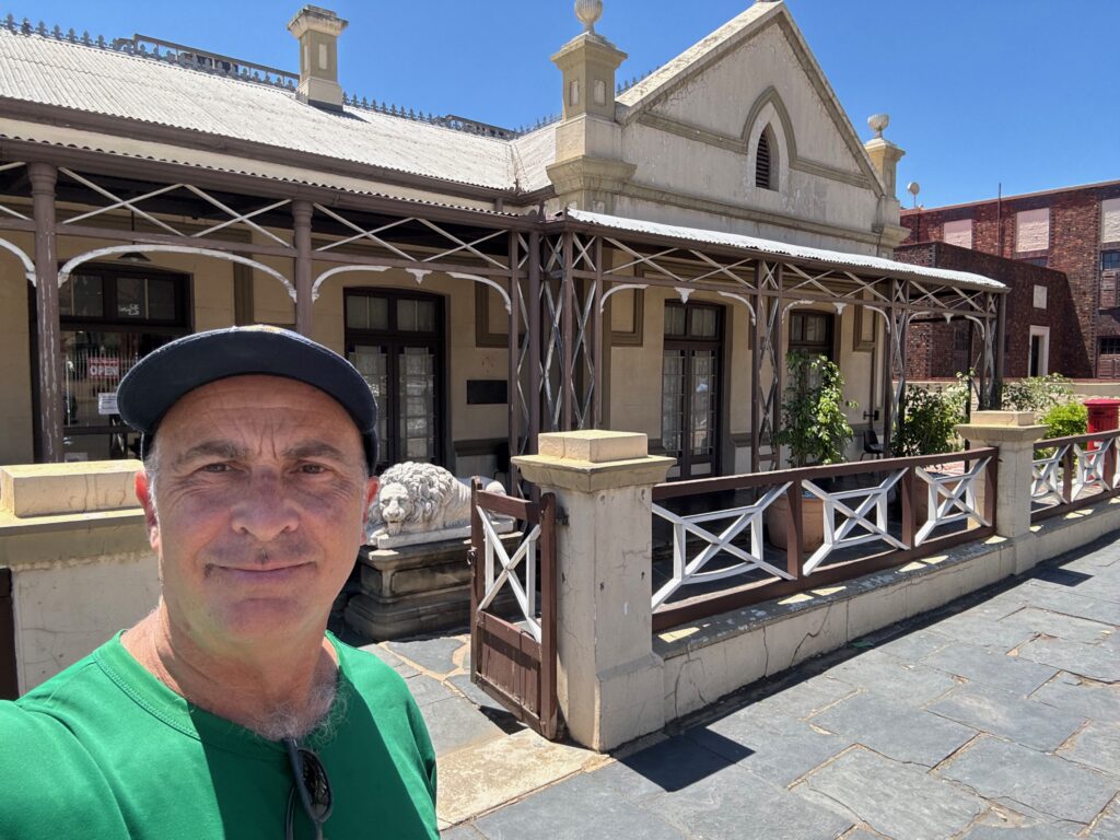 a man taking a selfie in front of a building