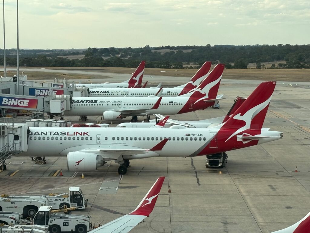 a group of airplanes parked on a runway