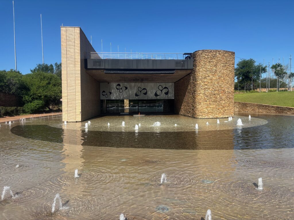 a building with a fountain in the water