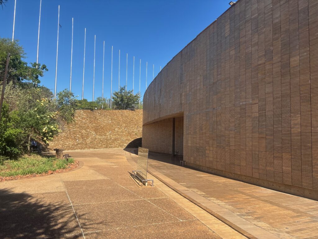 a building with a stone wall and a stone walkway