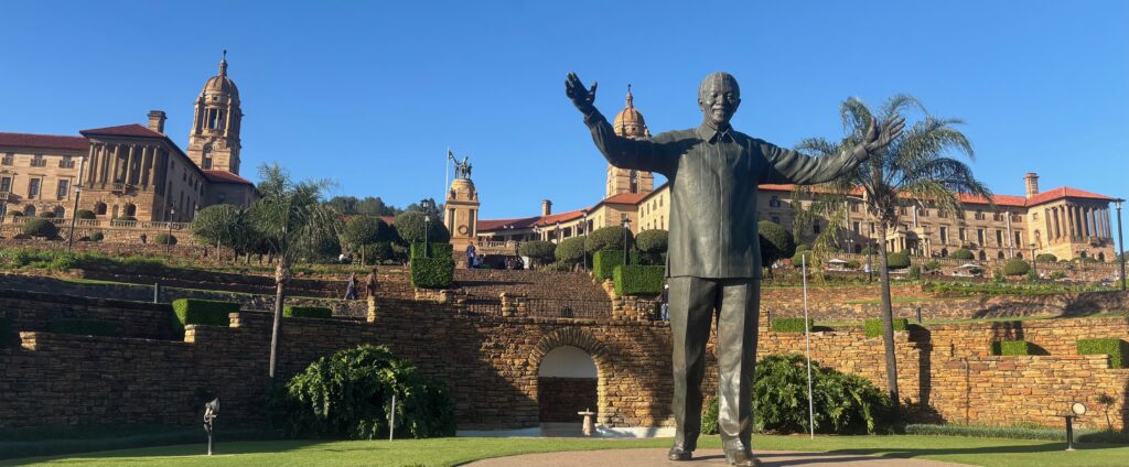 a statue of a man in front of a stone wall