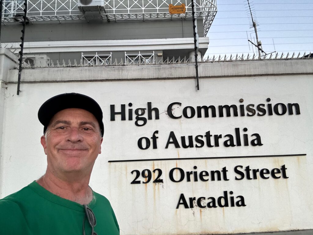 a man in front of a sign